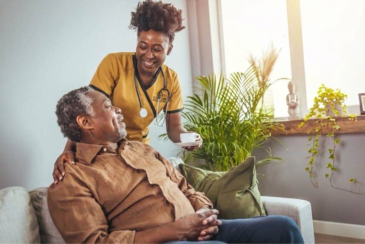 A supportive caregiver holding hands with an elder